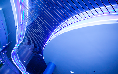 Abstract lights and shapes adorn the ceiling with purplish-blue hues.
