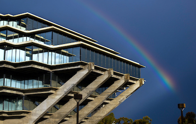 A rainbow appears to the side of the Geisel Library on the UC San Diego Campus
