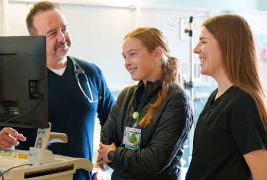 photo of clinician mentoring medical students