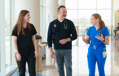 doctor walking with medical students in hospital