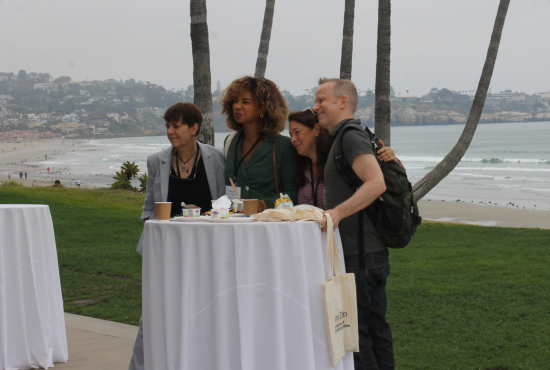 Photo of a team of healthcare clinicians posing together in front of a table