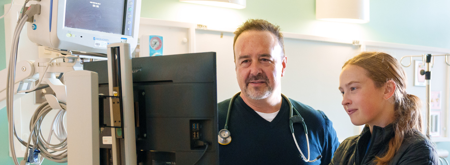 doctor mentoring students in clinical setting