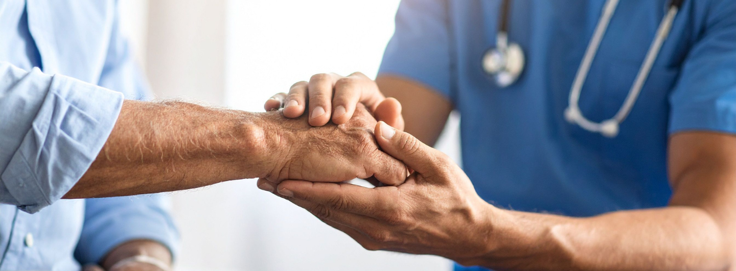 doctor holding patient's hand
